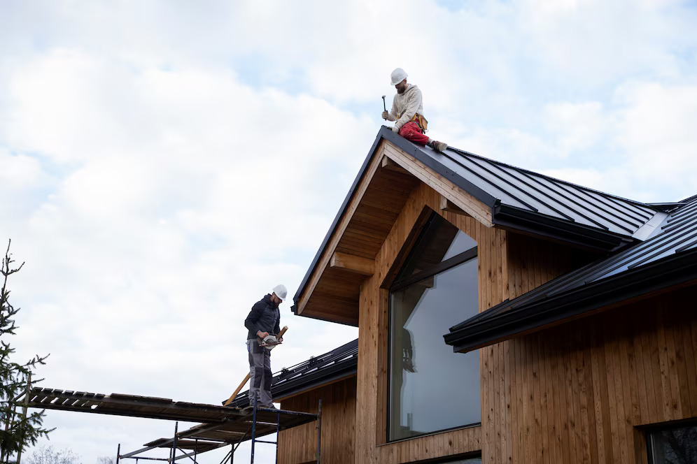 ROOFING Sample home from Red Door Contracting. White facade with wood shingle accents.